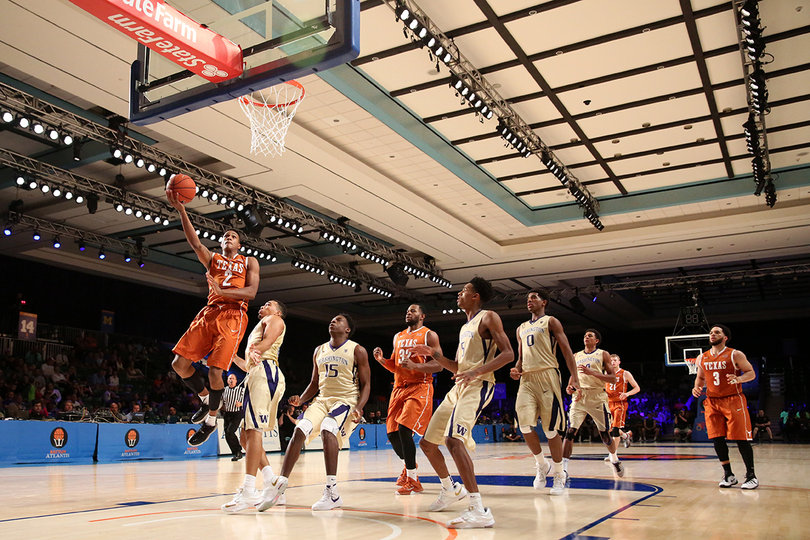 Texas guard Demarcus Holland (2) lays in an uncontested layup as Washington players look on. 