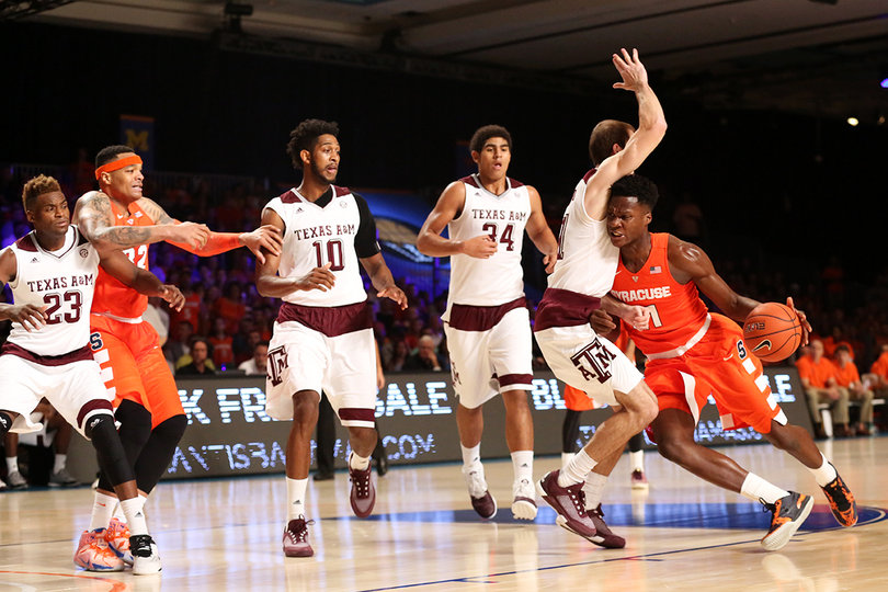 Roberson takes on a Texas A&M defender as he dribbles with his left hand.