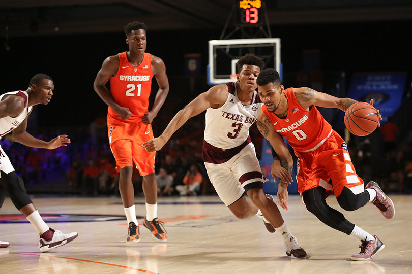 Point guard Michael Gbinije (0) dribbles past Texas A&M guard Admon Gilder (3) as Tyler Roberson (21) watches. 