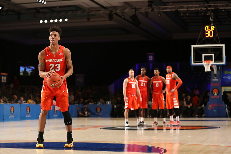 Richardson shoots a free throw as four teammates look on from the other side of the court.
