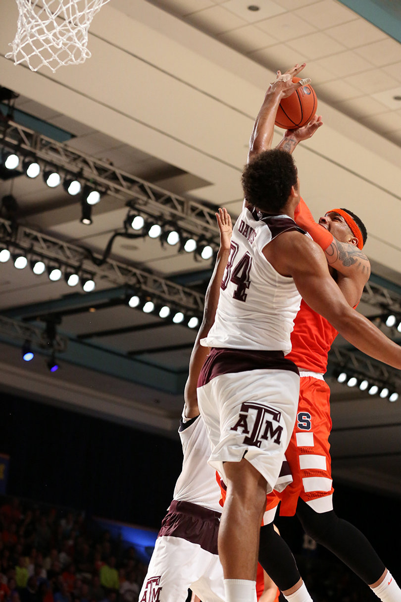 Coleman is blocked by Davis while taking a jump shot.