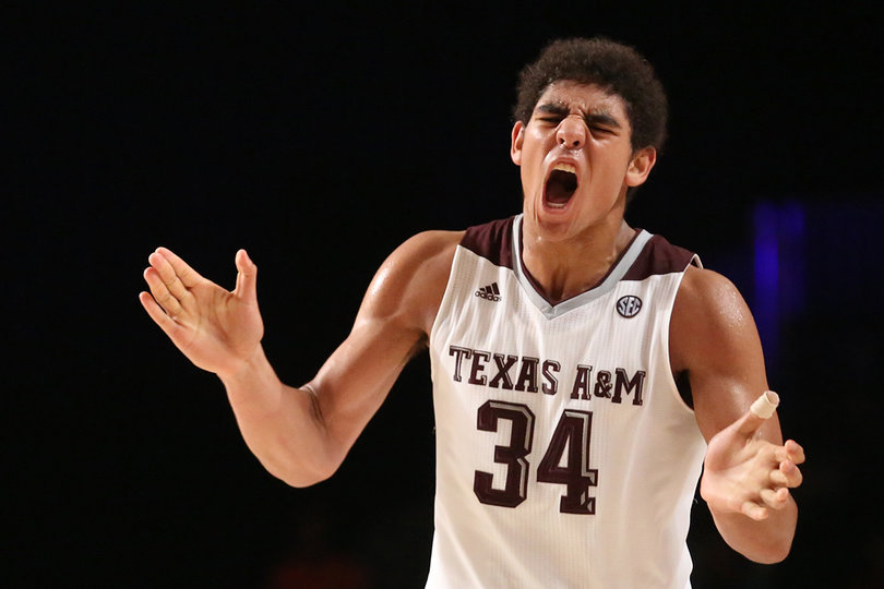 Davis claps in excitement as the game's intensity rises.