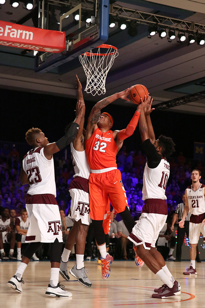 Coleman takes on three Aggies defenders as he goes up at the rim.