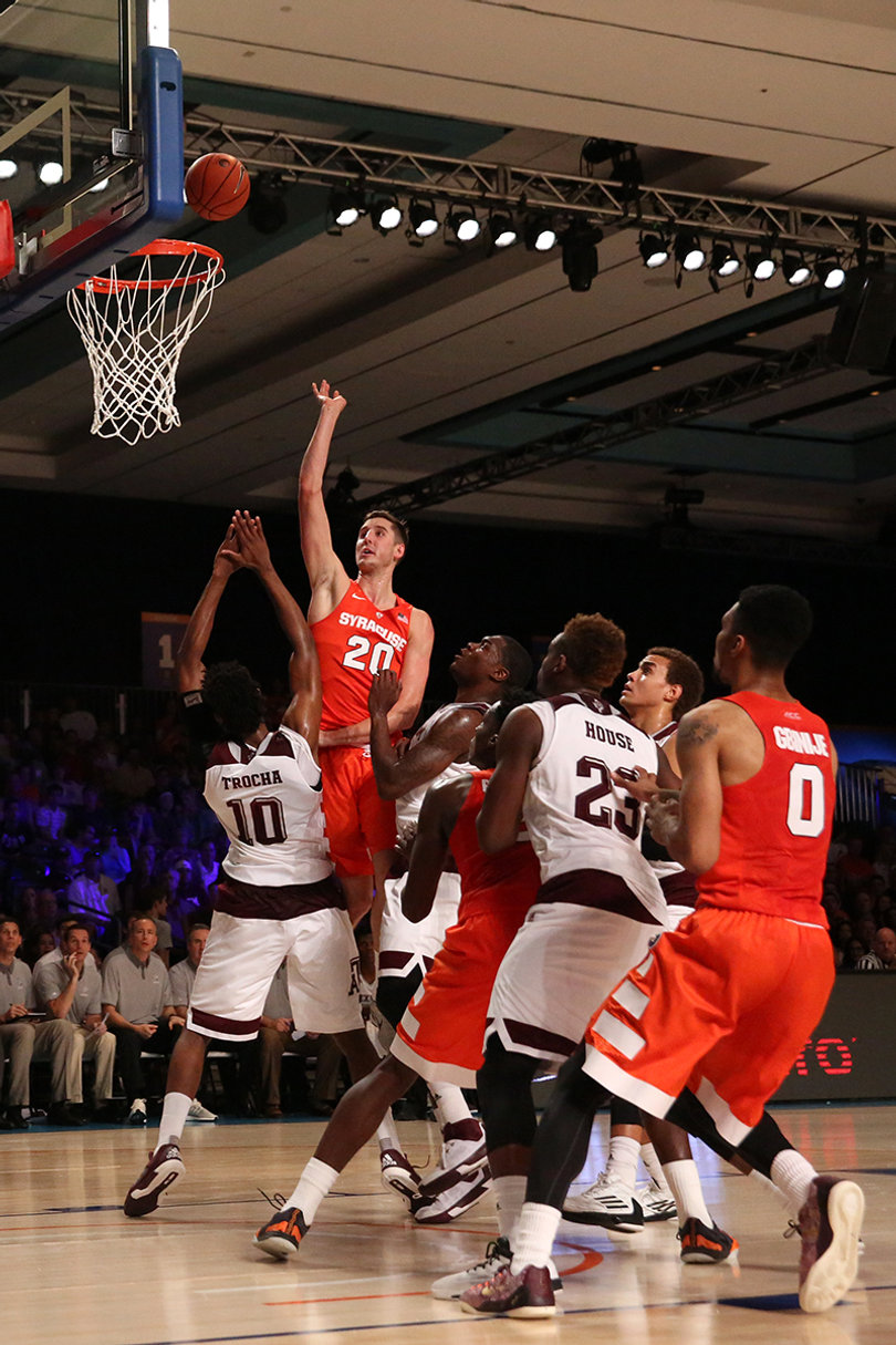 Syracuse forward Tyler Lydon (20) floats a shot toward the basket as Tonny Trocha-Morelos (10) stands his ground. Lydon scored 13 points, the fourth-most among SU players.
