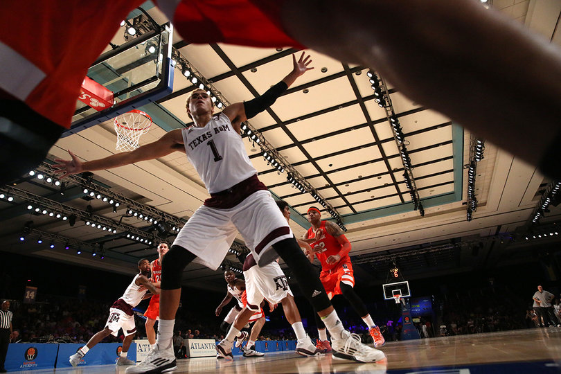 Texas A&M's DJ Hogg (1) defends a Syracuse inbounds pass.