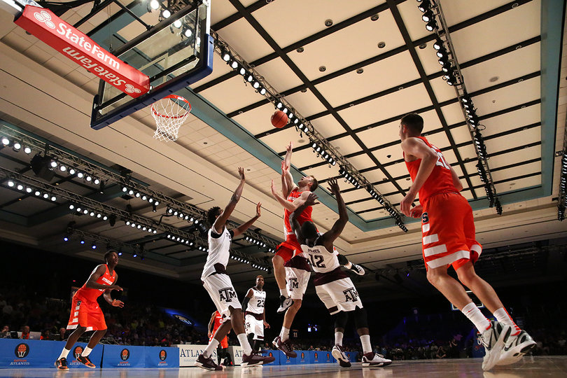 Cooney shoots a floater in the lane with two Aggies defenders in front of him.