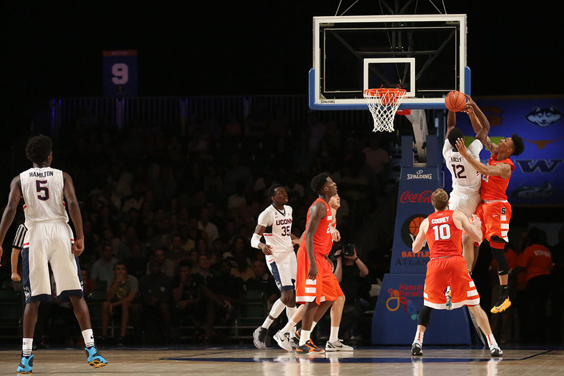 Richardson battles with 6-foot-10 UConn forward Kentan Facey (12) for the ball. 
