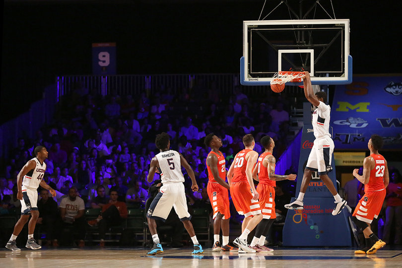 Roberson, Lydon, Gbinije and Richardson watch a UConn player dunk. 