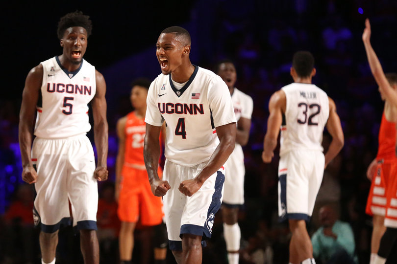 Huskies guard Sterling Gibbs (4) celebrates with forward Daniel Hamilton (5) in the background. 