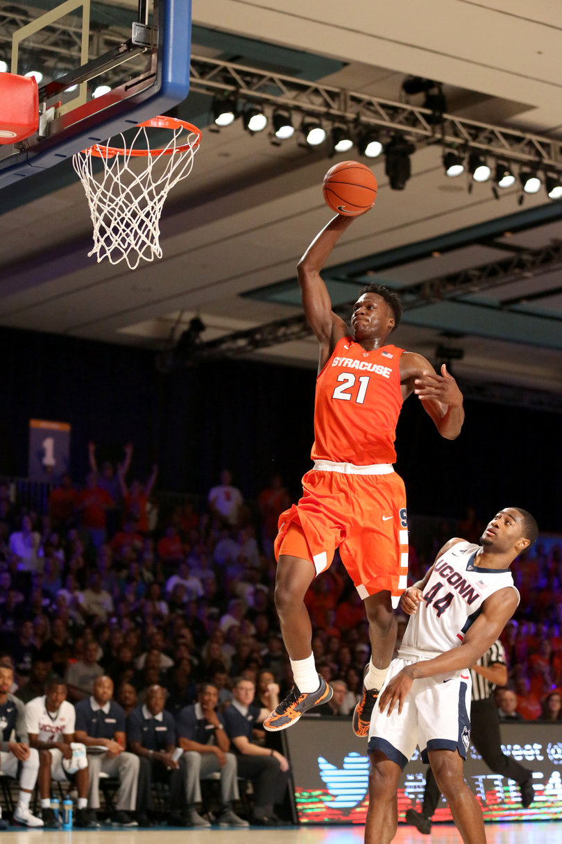 Forward Tyler Roberson leaps for a dunk as UConn's Rodney Purvis (44) looks on. Roberson finished 14 points. 