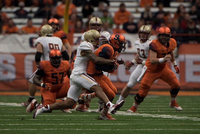 A Boston College defender drags down a Syracuse player in the first half of Shafer's last game as Syracuse's head coach. 
