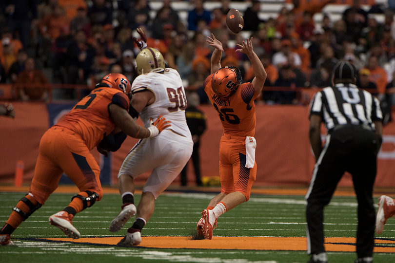 Mahoney tries to bring down a high snap as Boston College defensive lineman Connor Wujciak moves past Syracuse offensive lineman Rob Trudo. 