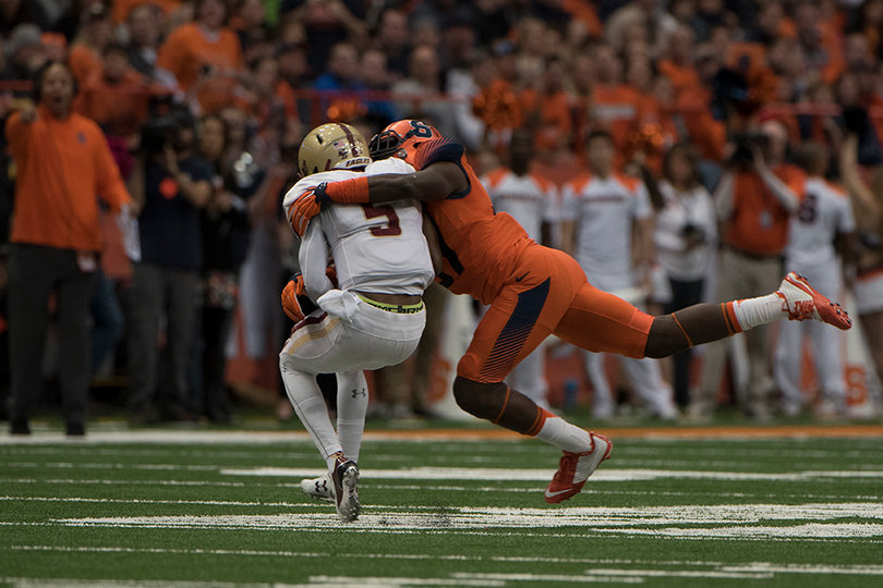 Syracuse linebacker Ted Taylor brings down Boston College quarterback Jeff Smith.