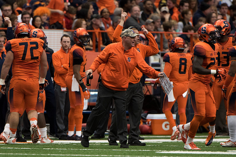 Shafer walks on the field to high-five his players in his last game as head coach. He finished his tenure 14-23. 
