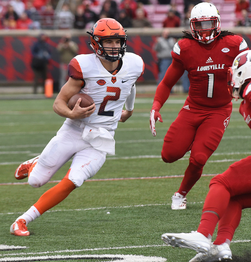 Eric Dungey runs the ball as Louisville linebacker Keith Brown (1), chases the quarterback down. A fourth-quarter hit knocked Dungey out of the game. 