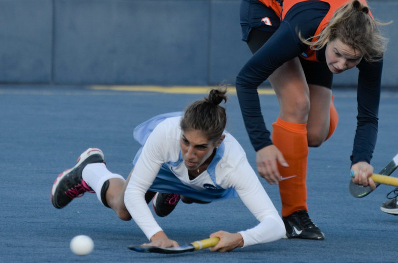 A North Carolina player falls to the ground as SU's Lies Lagerweij looks on.