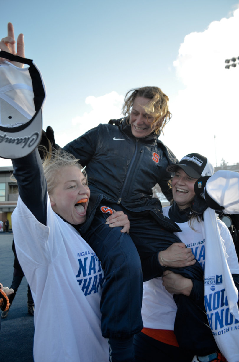 Roos Weers and Lagerweij hoist head coach Ange Bradley in the air.