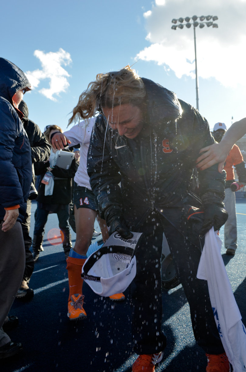 Bradley shakes off the water from the team's water cooler after being doused.