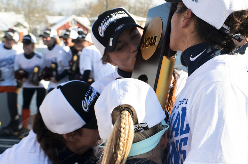 Syracuse players kiss the national championship trophy.