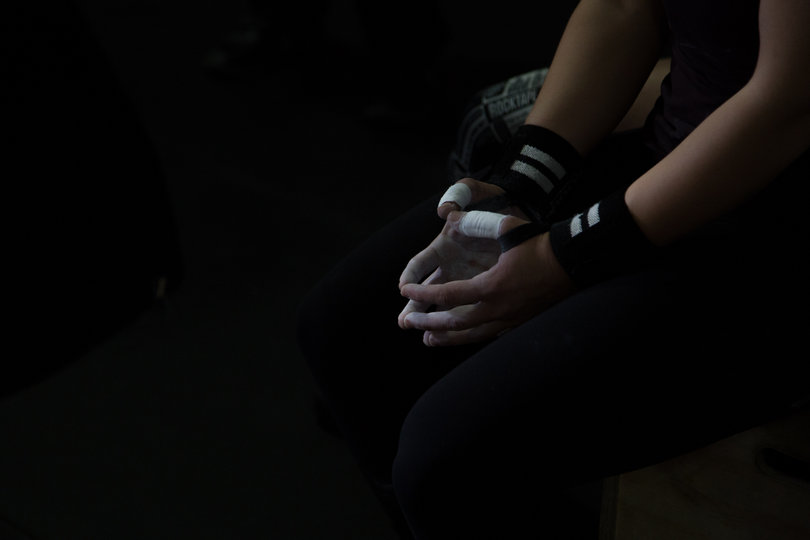 Amanda Bingham, from Camillus, New York, waits for the second round of the weightlifting competition to begin.
