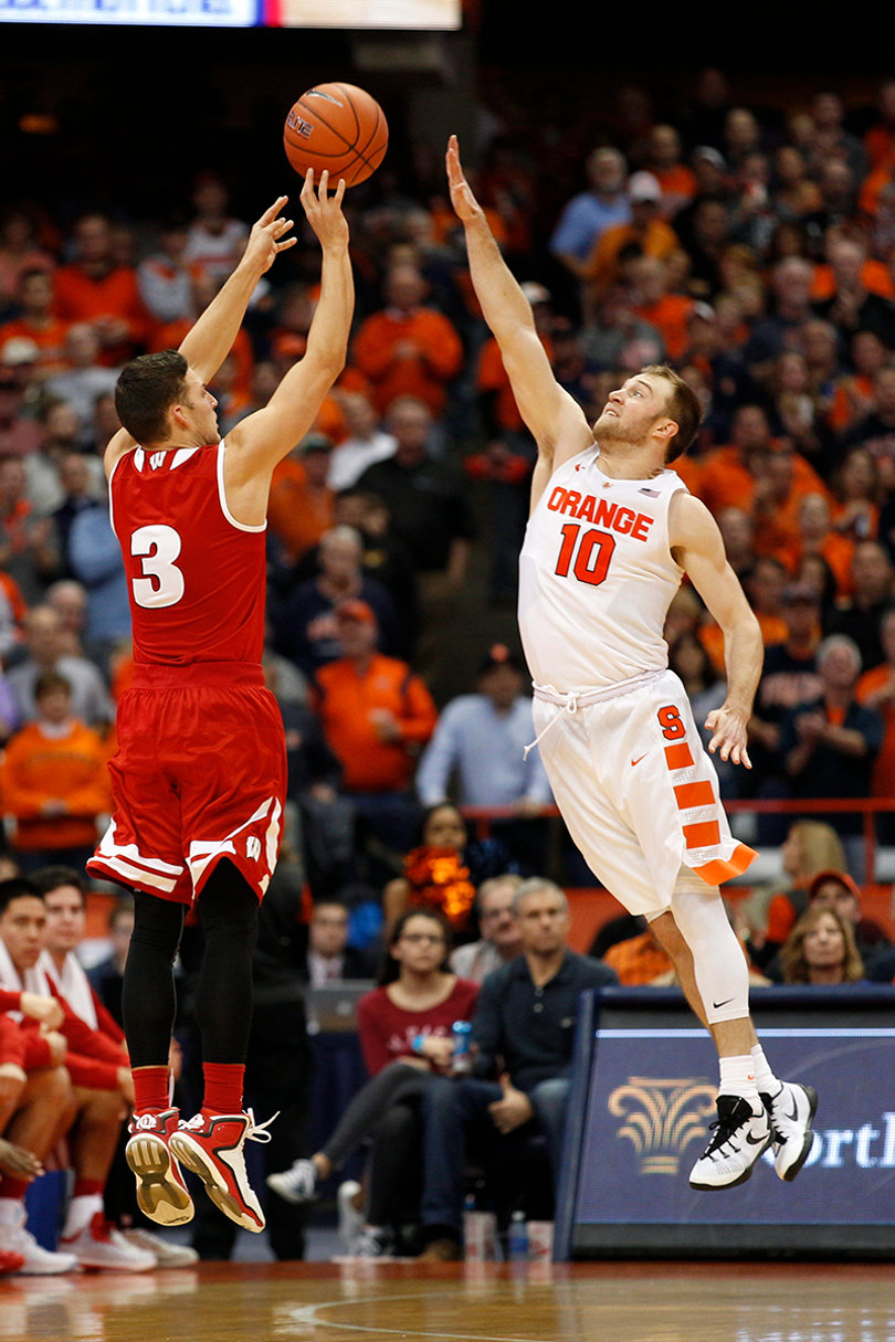 Cooney contests a shot by Showalter, who scored six points and cleaned up five rebounds. 