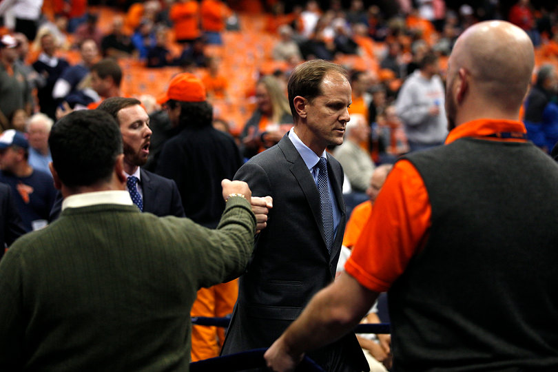 Syracuse assistant coach Mike Hopkins walks with fellow assistant Gerry McNamara through the Carrier Dome before SU's game against the Badgers. 