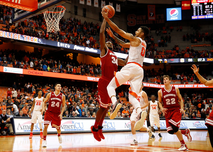 Gbinije lays up a shot attempt over Badgers forward Vitto Brown, who recorded three blocks for the Badgers. 