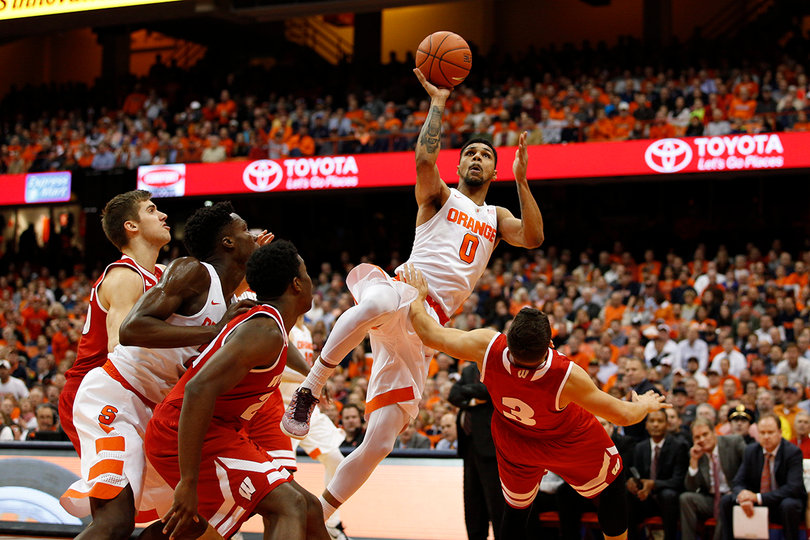 Syracuse point guard Michael Gbinije floats a shot over a Wisconsin defender. 