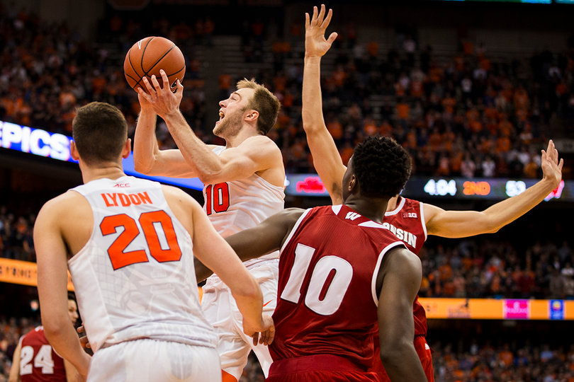 Cooney hoists a shot as Lydon and Hayes look on. Lydon tallied just four rebounds against Wisconsin. 