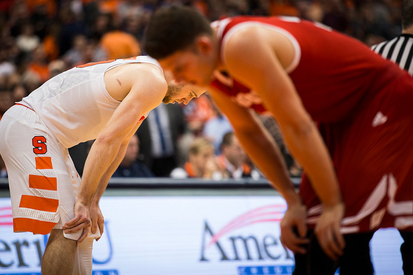 Cooney and a Wisconsin player bend over with their hands on their knees. The Badgers and Orange both played their first overtime games of the season. 