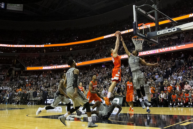 SU forward Tyler Lydon rises for a dunk against Georgetown's Reggie Cameron (5). 
