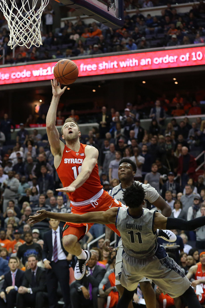 SU guard Trevor Cooney drives to the hoop as Copeland gets in front of him. Cooney scored 11 points in the contest.