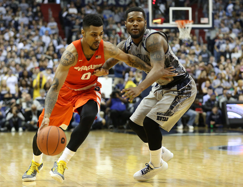 Syracuse guard Michael Gbinije dribbles past Hoyas guard D'Vauntes Smith-Rivera. Gbinije scored 23 points and five assists. 
