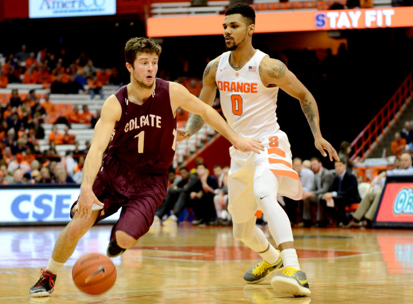 Michael Gbinije defends as Tillotson penetrates the interior of Syracuse's defense.