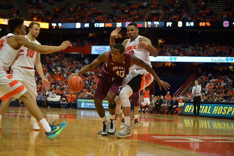 Colgate's Jordan Swopshire dribbles toward the paint while Dajuan Coleman defends him.
