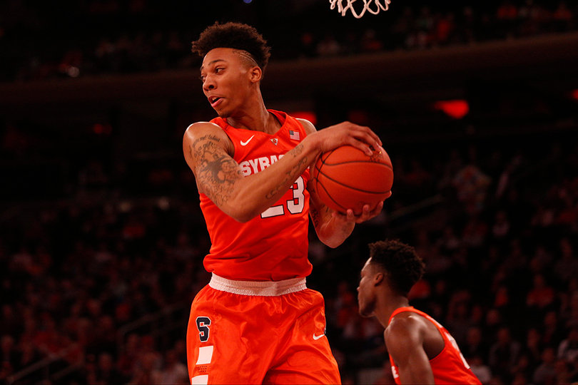 Malachi Richardson secures the ball underneath the hoop.