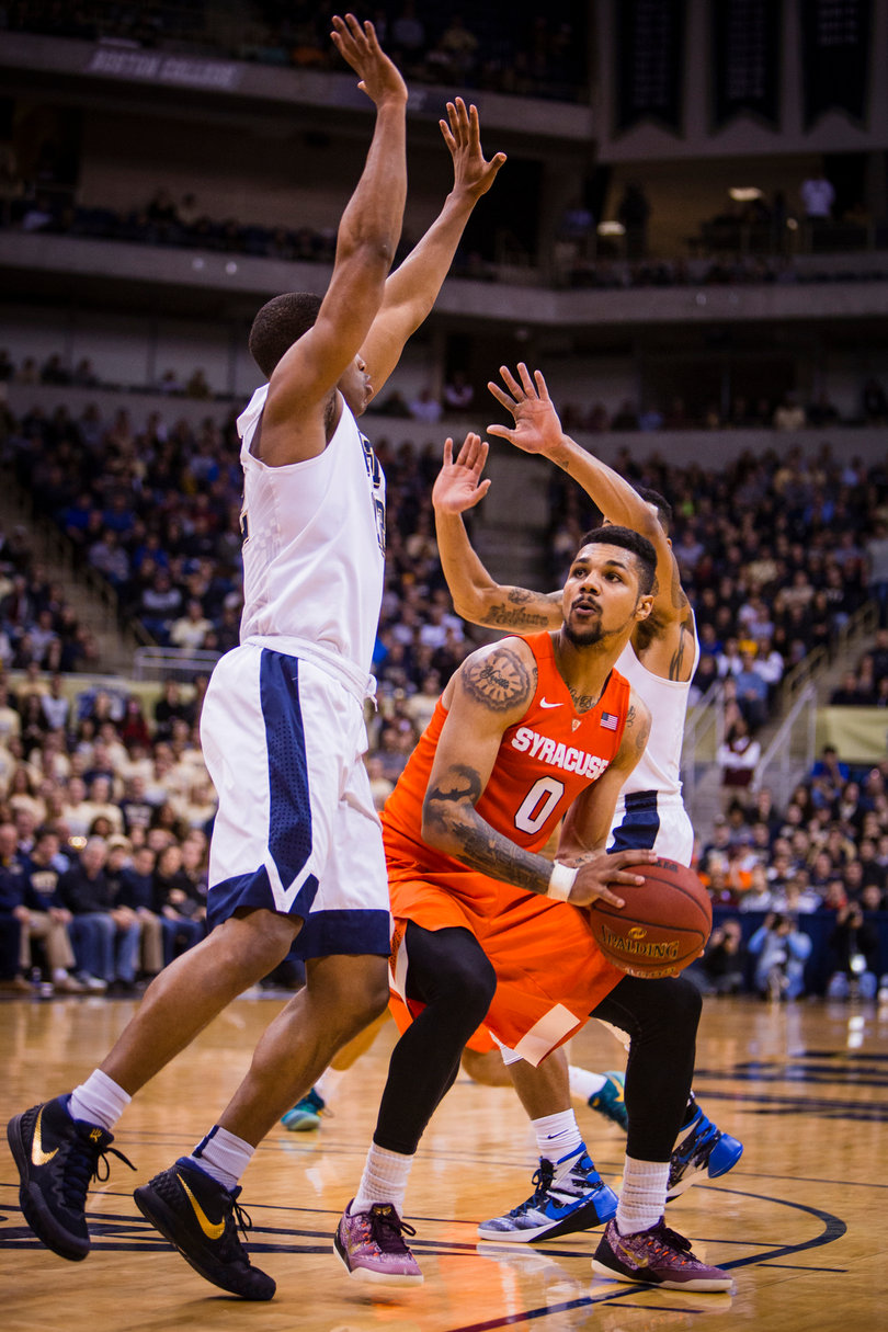 Gbinije is surrounded by two Pitt defenders in the paint.