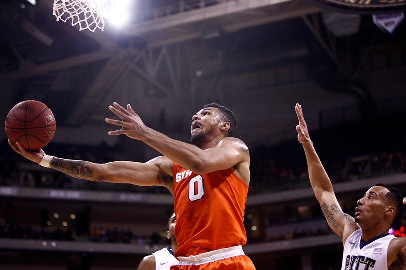 Gbinije tries to lay in a bucket as two Pittsburgh defenders look on. He scored 14 points and dished seven assists. 