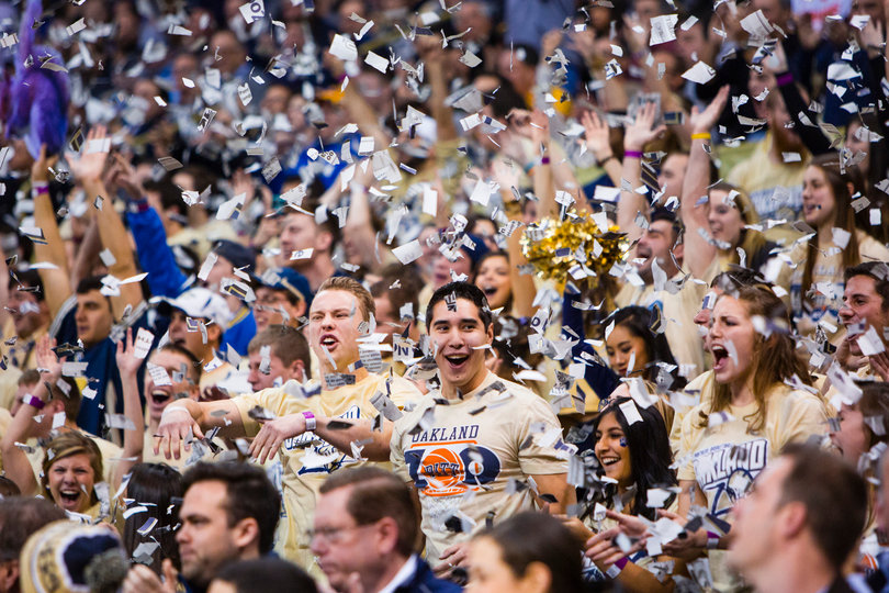 Members of Pittsburgh's student section, the Oakland Zoo, toss shreds of paper into the air while cheering on the Panthers.