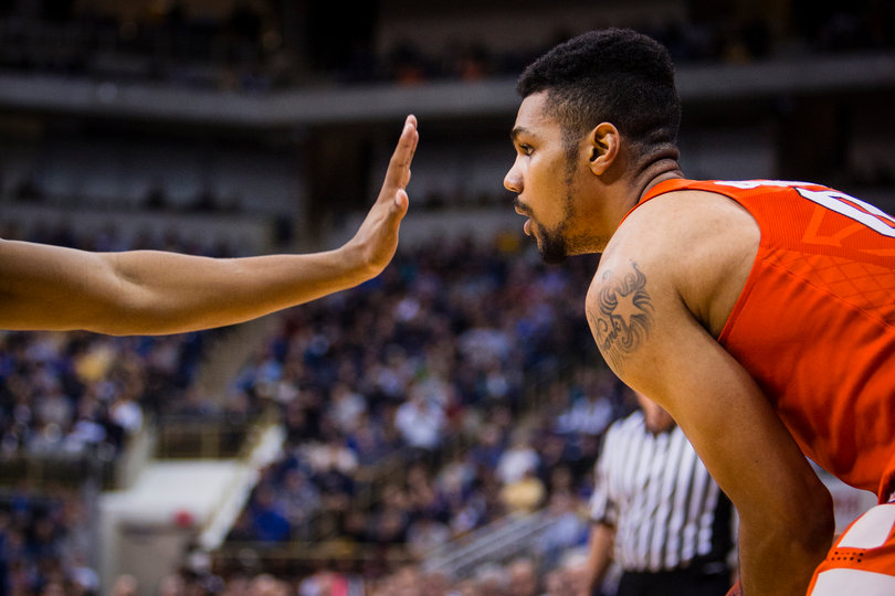 Gbinije stands near the perimeter of the court as a Pittsburgh defender sticks a hand immediately in front of his face.