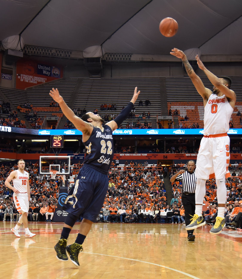 Senior point guard Michael Gbinije launches a deep shot on Tuesday night in the Carrier Dome. He scored 17 points in the win.