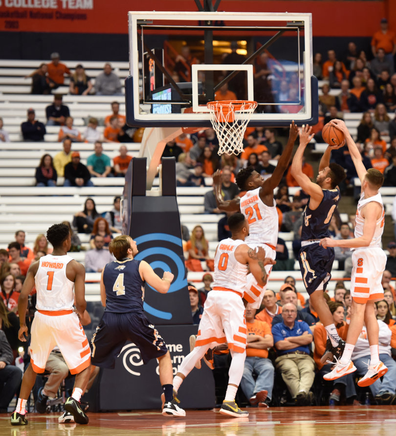Lydon makes a block from behind as Roberson attacks the MSU player from the front.