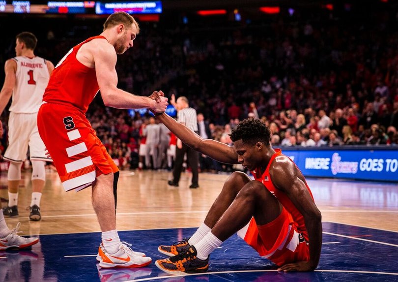Cooney helps lift Roberson off the court.