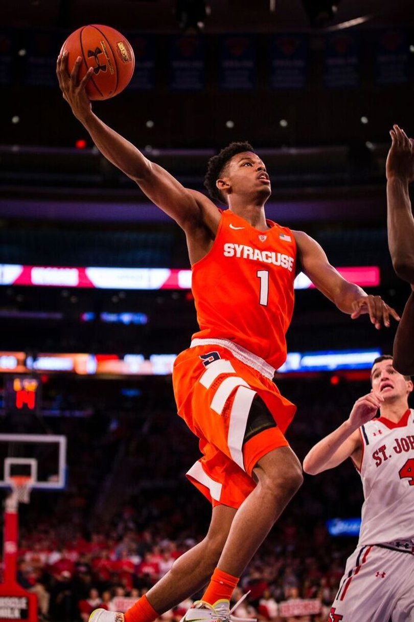 Freshman guard Frank Howard holds the ball out with his right hand as he soars to the hoop.