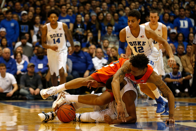 Richardson tumbles over a Duke player while trying to grab a loose ball off the floor.