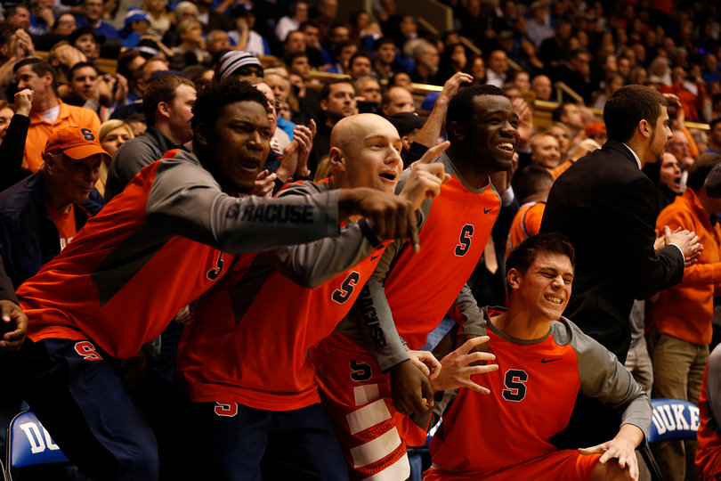 Walk-ons Doyin Akintobi-Adeyeye, Evan Dourdas, Adrian Autry and Mike Sutton cheer on their teammates from the SU bench.