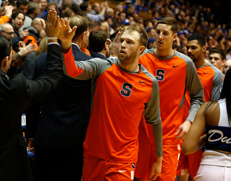 Trevor Cooney slaps high-five with members of Syracuse's staff.