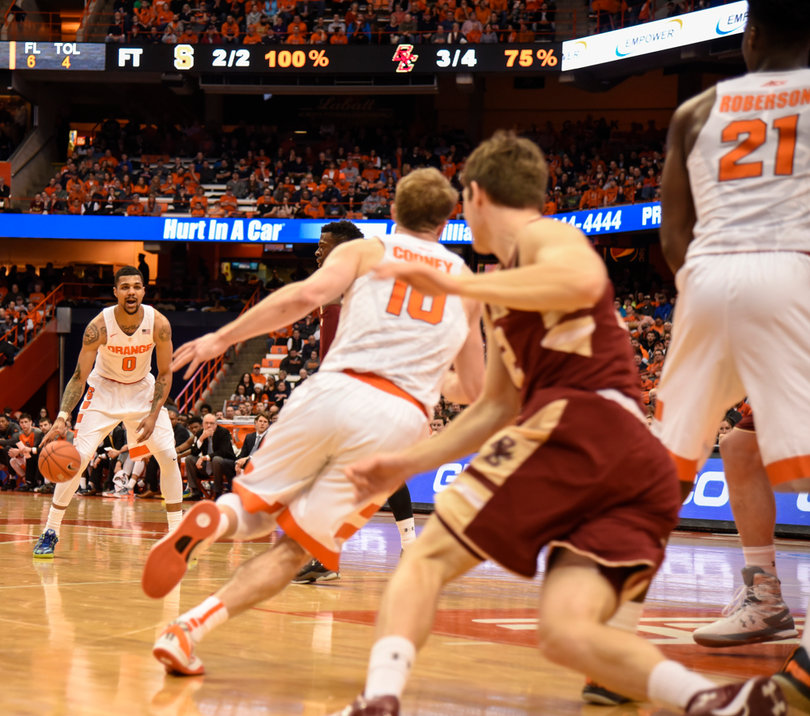 Gbinije sets up Syracuse's offense as Trevor Cooney (10) tries to get away from the Eagles' defender.