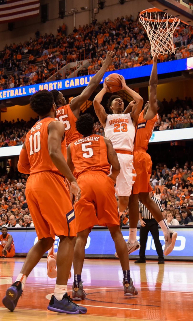 Syracuse freshman Malachi Richardson (23) attacks the rim while being surrounded by four Clemson defenders. Richardson scored a career-high 21 points on Tuesday night in the Carrier Dome.