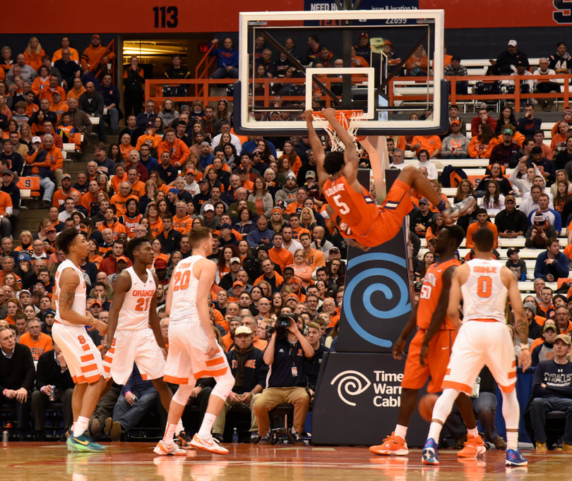 Clemson's Jaron Blossomgame hangs on the rim inside the Carrier Dome. He registered 20 points and six boards.